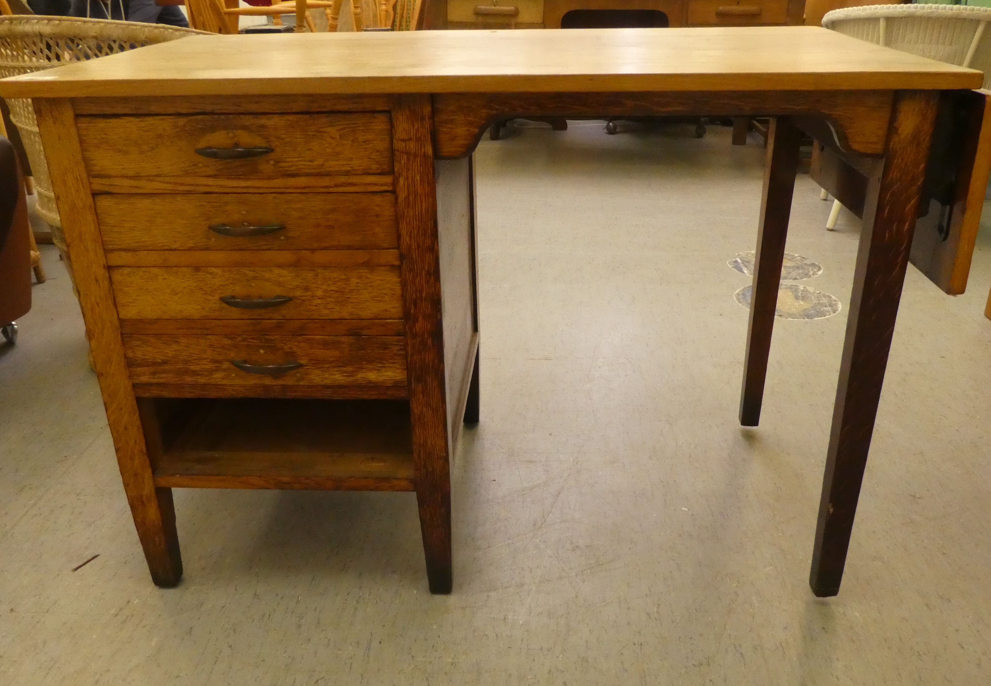 A modern oak single pedestal desk with four drawers, raised on block legs  29"h  42"w