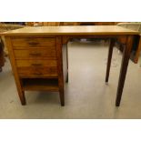 A modern oak single pedestal desk with four drawers, raised on block legs  29"h  42"w