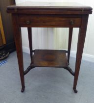 An Edwardian marquetry inlaid rosewood envelope card table with a frieze drawer, raised on square,