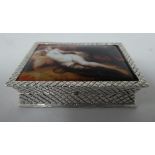 A silver coloured metal pin box, the hinged lid featuring an enamelled study, a reclining nude