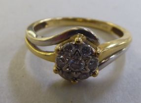 An 18ct gold diamond crossover cluster ring