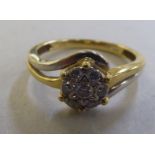 An 18ct gold diamond crossover cluster ring