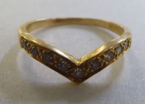 An 18ct gold wishbone design diamond set ring
