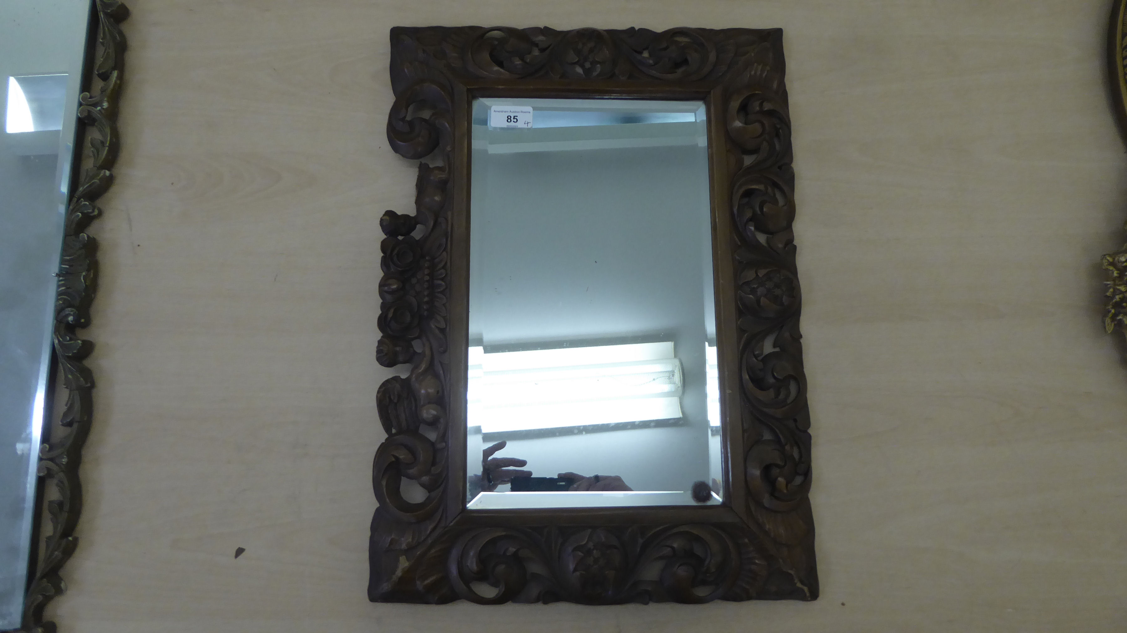 Four dissimilar mirrors: to include one with a bevelled edge, set in a carved and stained hardwood - Image 4 of 4