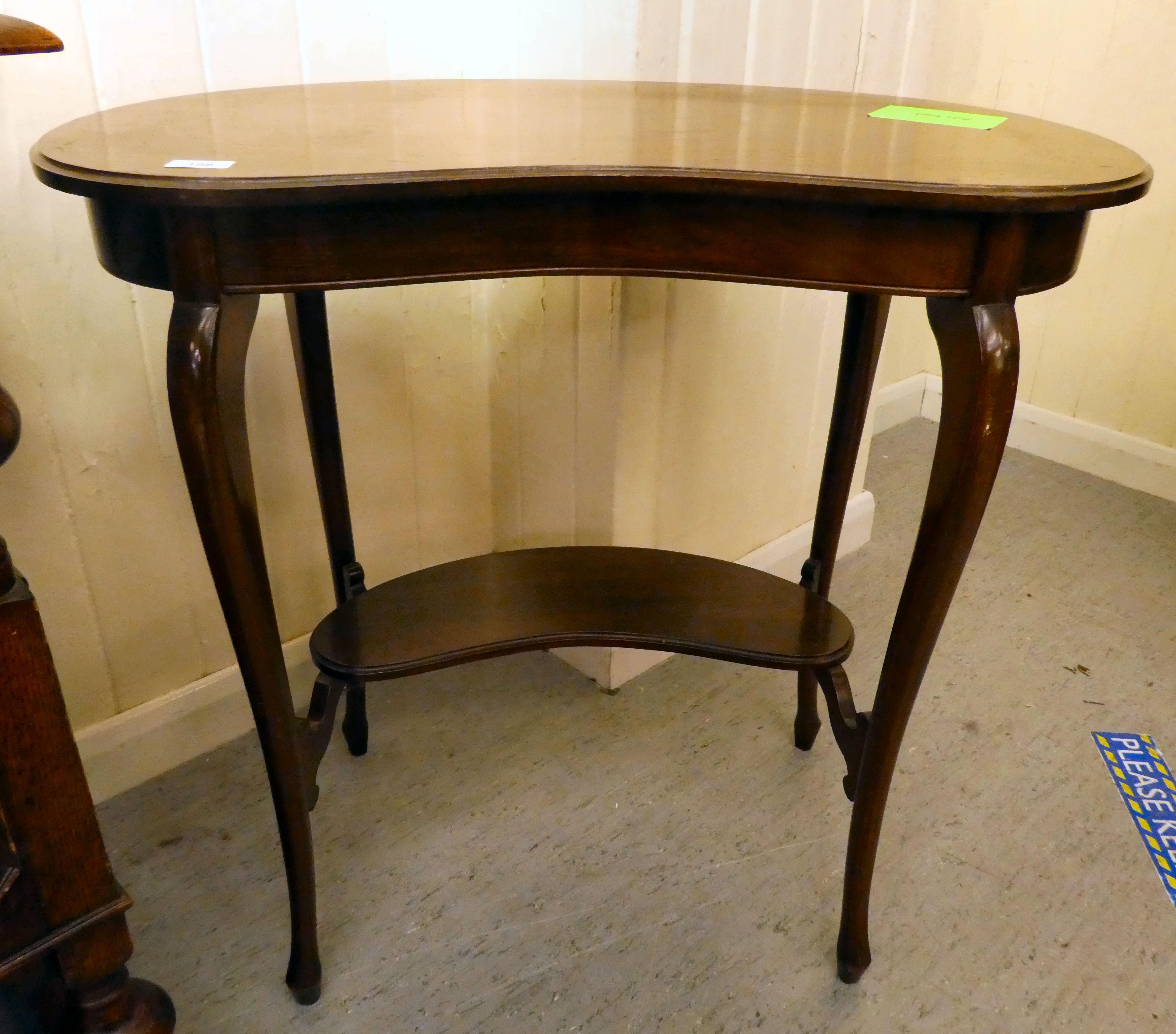 An Edwardian mahogany kidney shaped occasional table, raised on cabriole legs  28"h  30"w