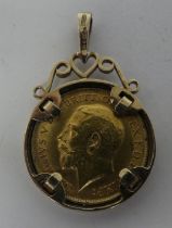 A George V half sovereign, St George on the obverse  1914, in a 9ct gold, scrolled pendant mount