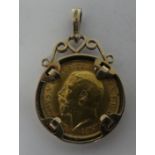 A George V half sovereign, St George on the obverse  1914, in a 9ct gold, scrolled pendant mount