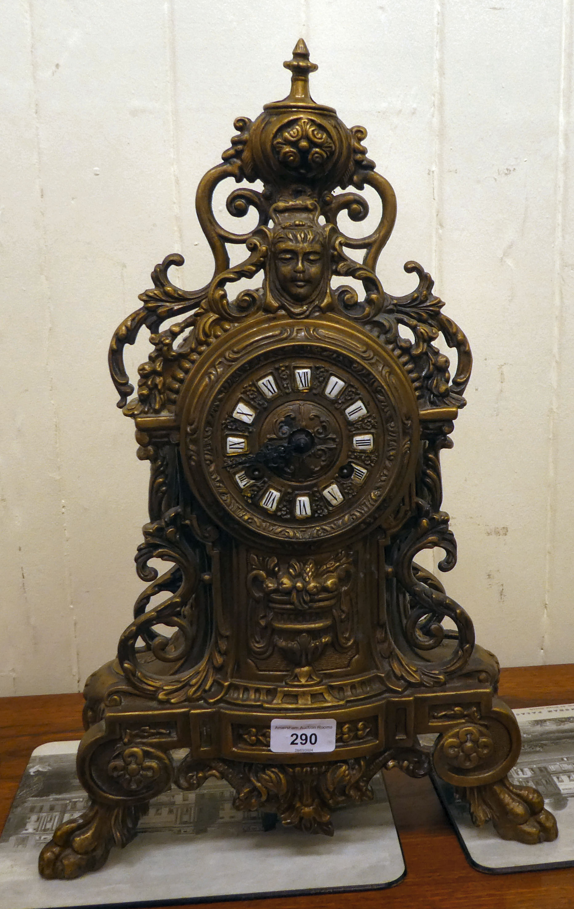 A modern Victorian design, gilt metal cased mantel clock of ornate architectural design, faced by