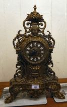 A modern Victorian design, gilt metal cased mantel clock of ornate architectural design, faced by