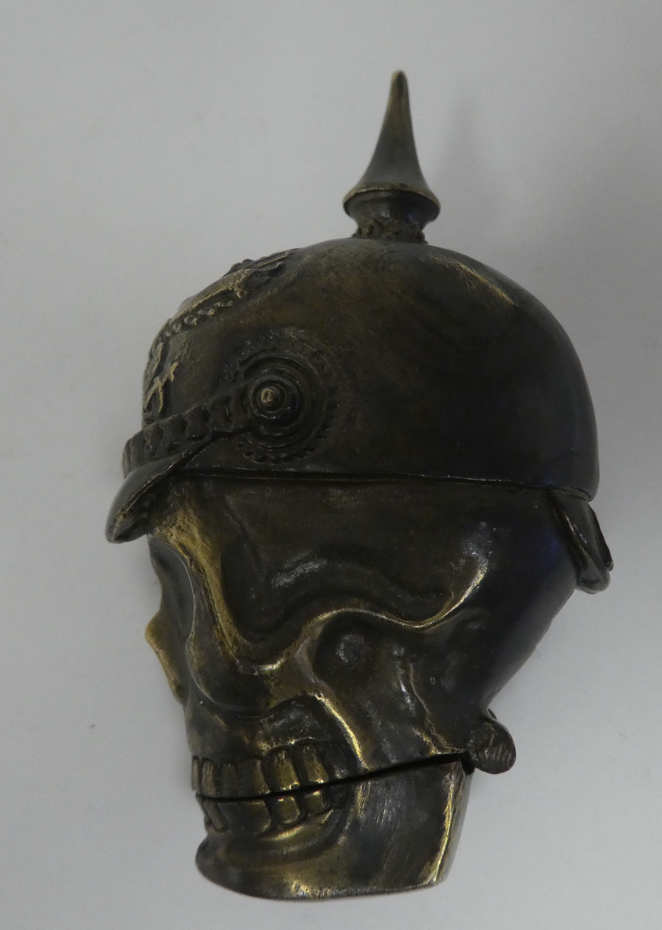 A brass vesta case, fashioned as a skull wearing a pickelhaube - Image 2 of 5