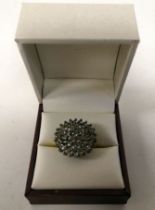 A yellow metal dress ring, set with cubic zirconia