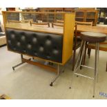 A 1960s laminate bar with a glazed upper section, raised on metal legs  38"h  42"w