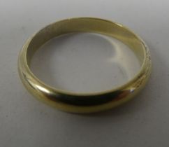 A gold coloured metal wedding ring  stamped 835