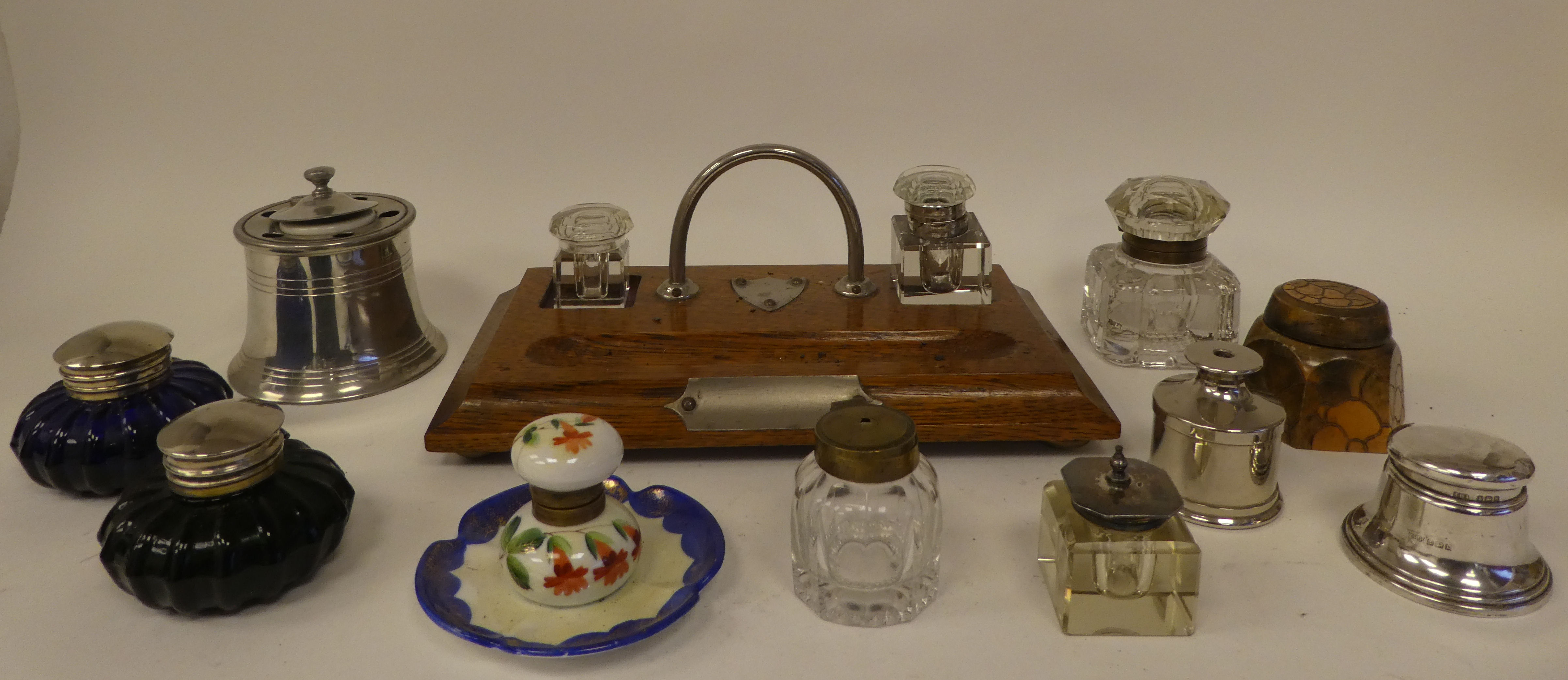 A miscellany of early 20thC and later inkwells: to include an example in silver, of capstan