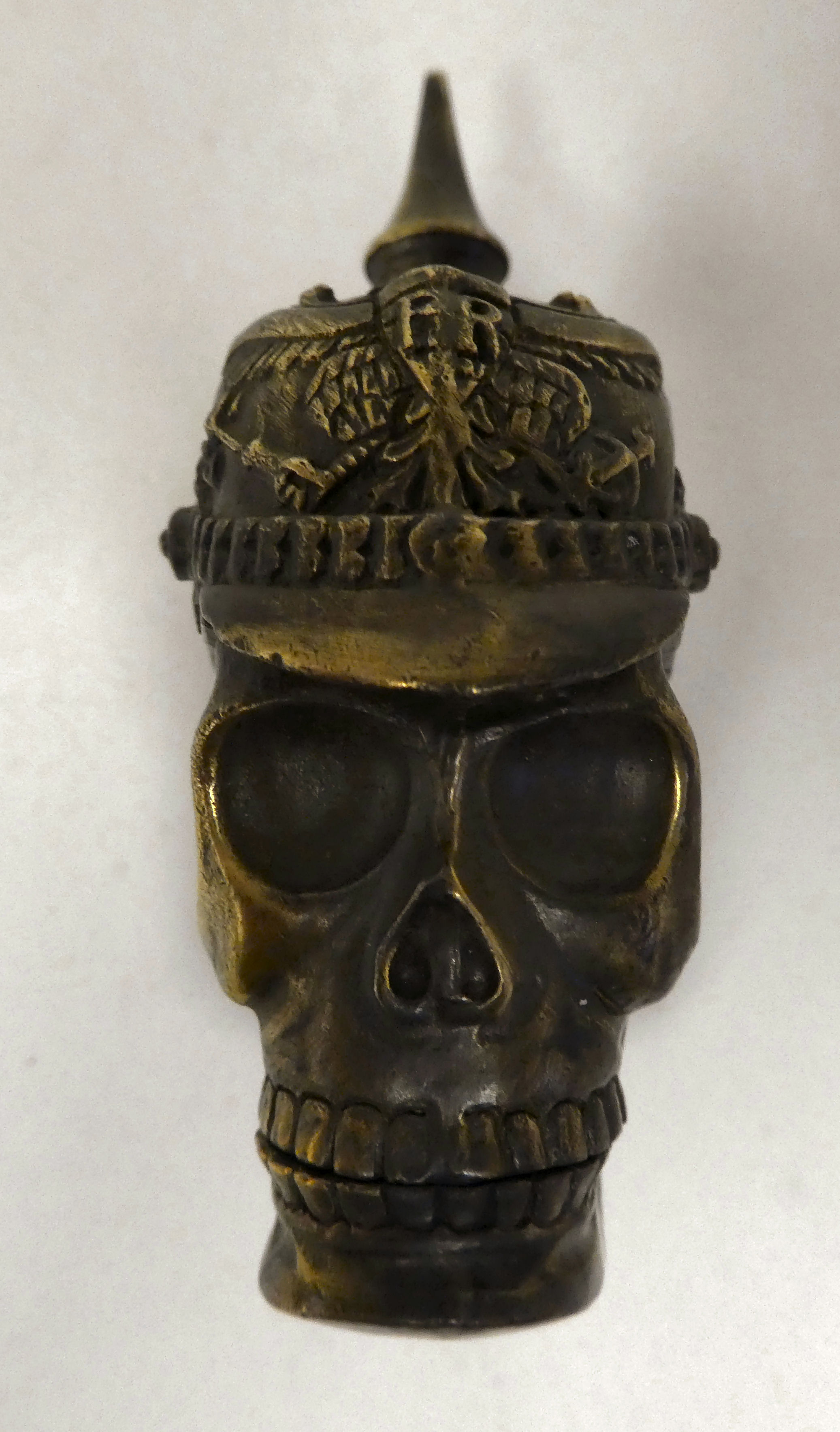 A brass vesta case, fashioned as a skull wearing a pickelhaube