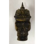 A brass vesta case, fashioned as a skull wearing a pickelhaube