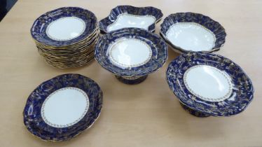 An early 20thC Wedgwood china dessert service, decorated with a gilded blue band