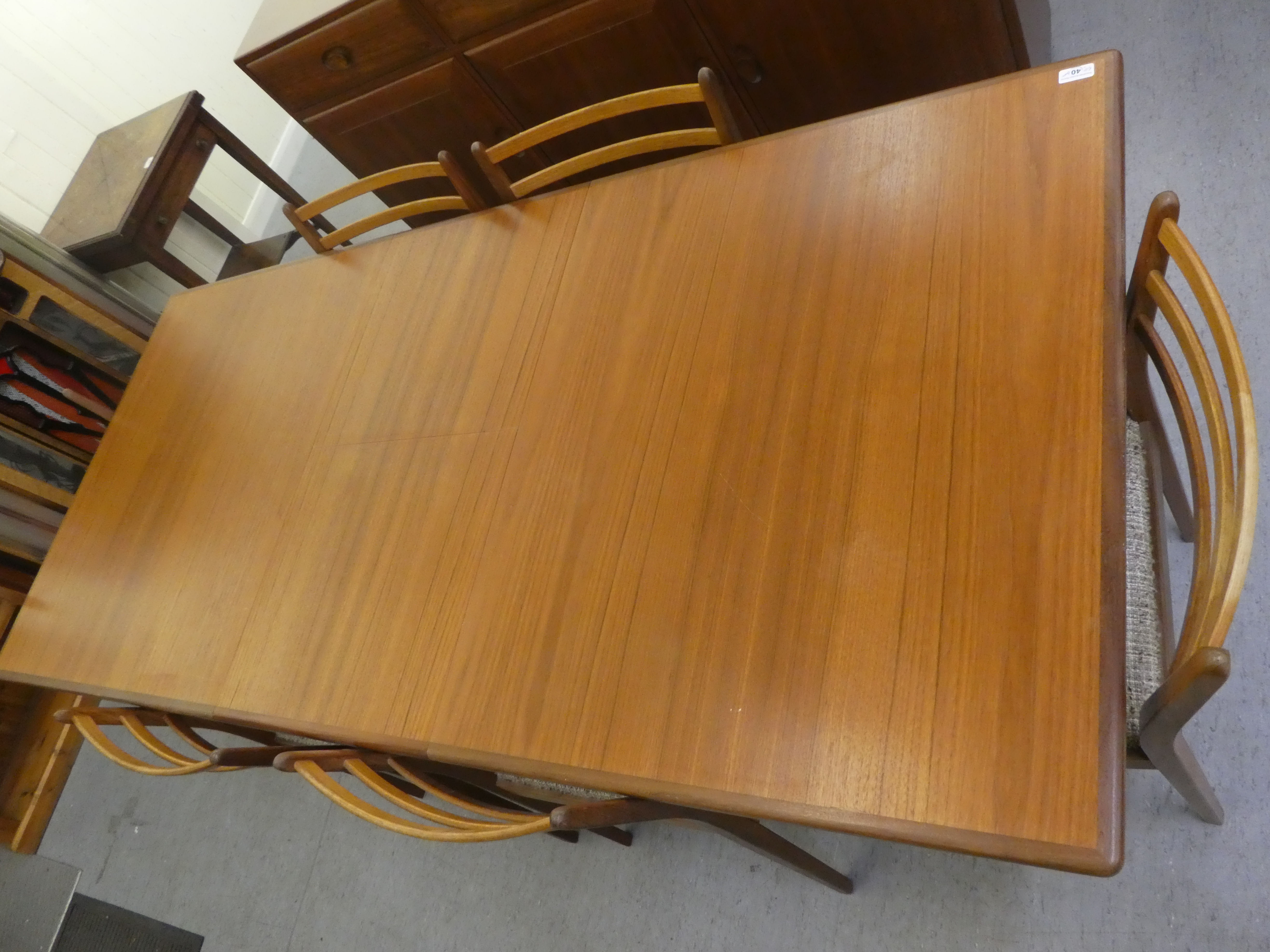 A 1970s teak G-Plan dining table, raised on turned, tapered legs  29"h  62"L extending to 80"L - Image 3 of 8