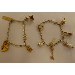 Two 9ct gold, gold coloured and other metal charms, on bracelets, one with a padlock clasp