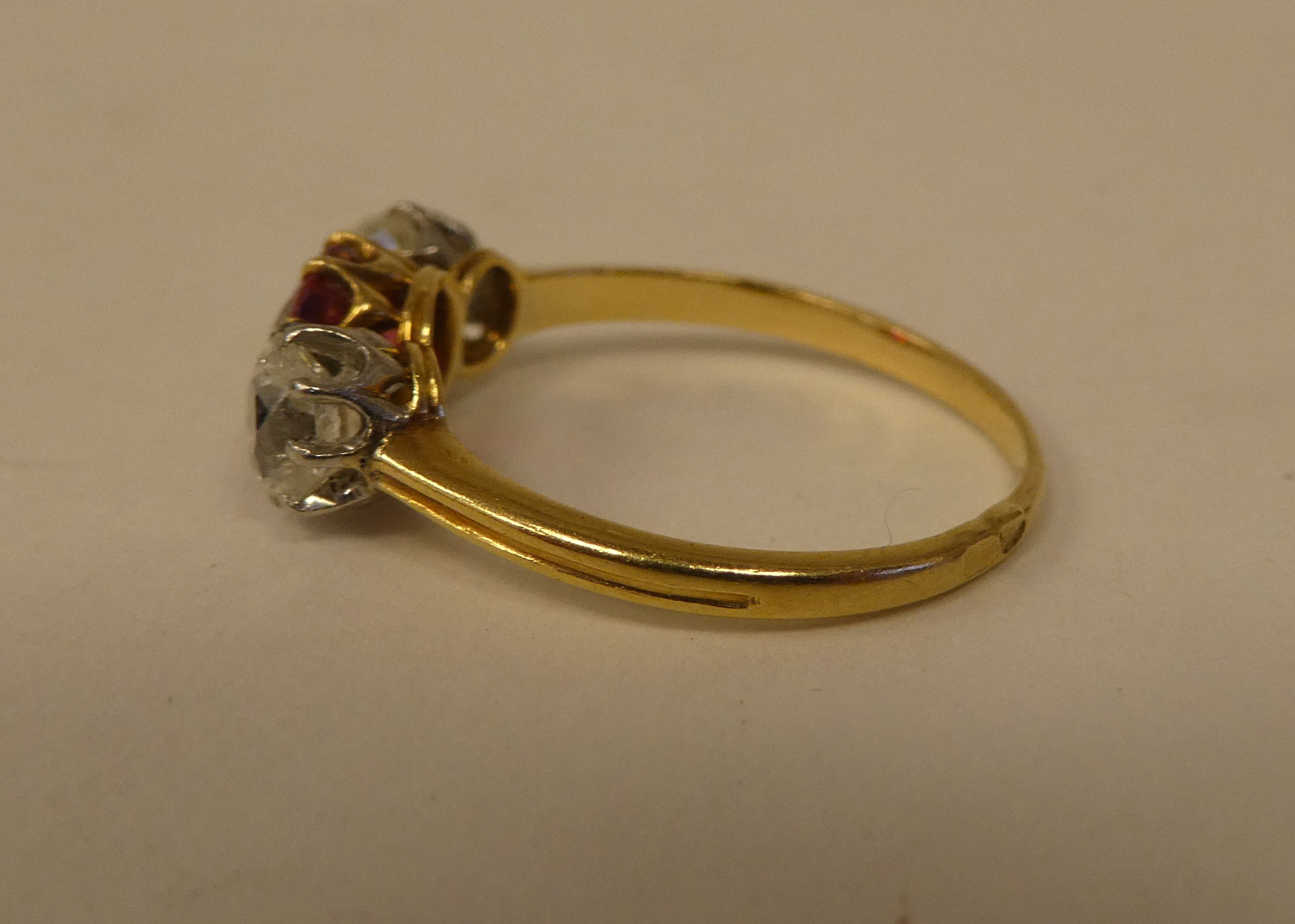 A gold coloured metal ring, claw set with an orange spiral and two diamonds - Image 4 of 5