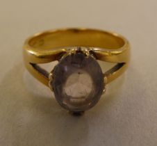 A 22ct gold ring, claw set with a smoky white stone