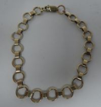 A gold coloured metal ring link bracelet