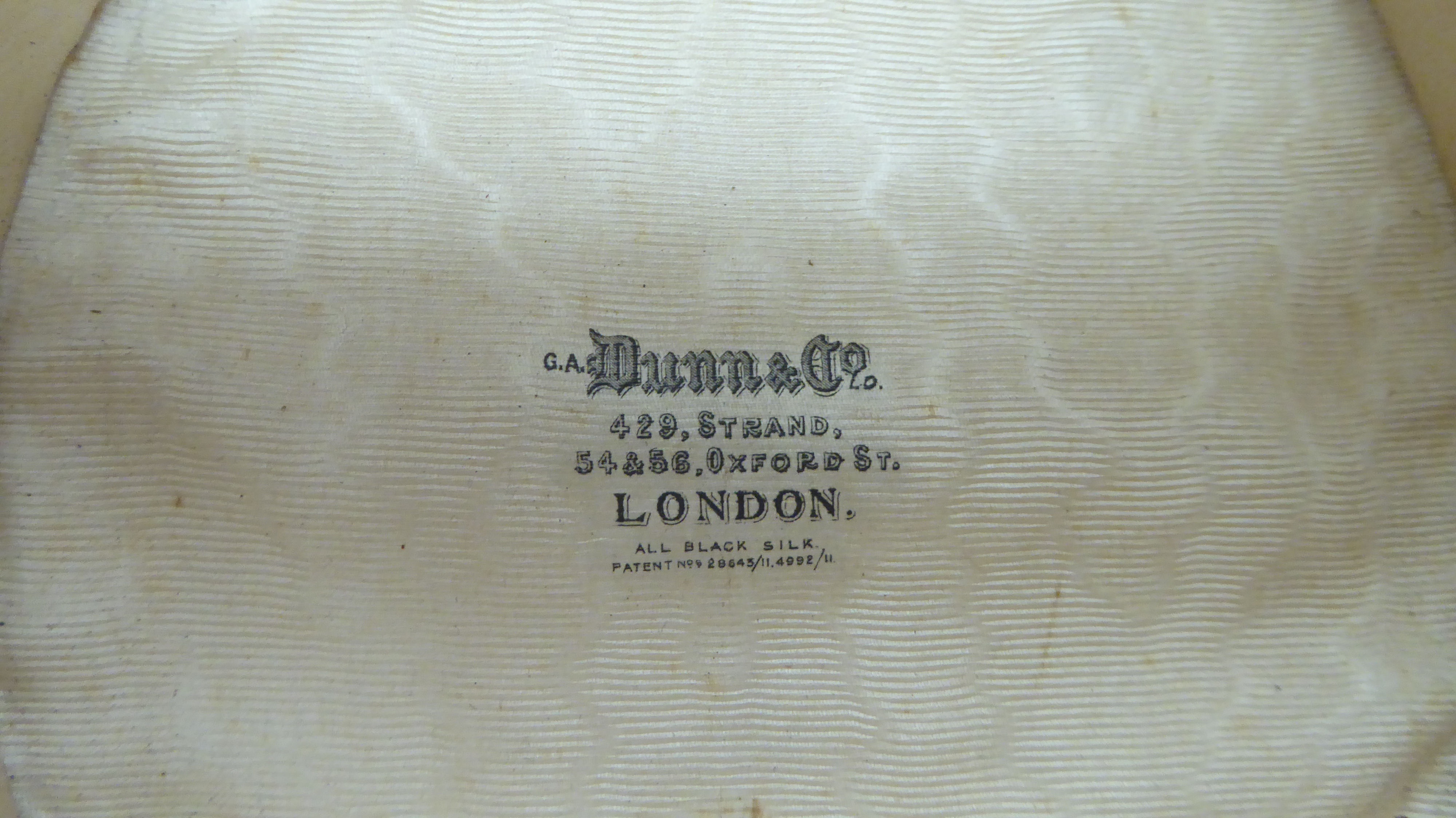 An early 20thC Dunn & Co black silk top hat  21cm front to back  16cm side to side - Image 2 of 4