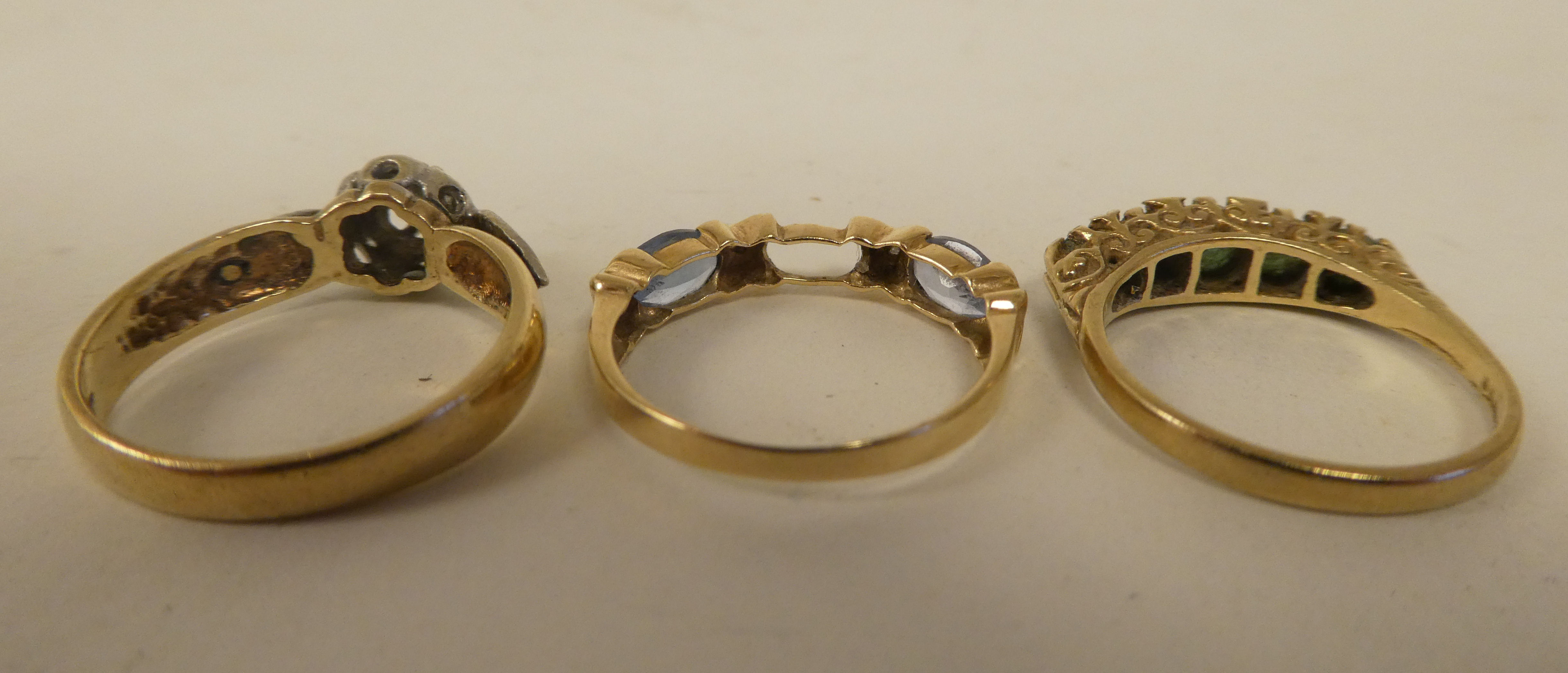 Three variously designed, 9ct gold rings: to include one set with aquamarine coloured stones - Image 3 of 3