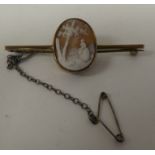 A yellow metal bar brooch, set with an oval cameo, a study of a woman in a woodland