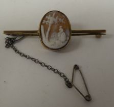 A yellow metal bar brooch, set with an oval cameo, a study of a woman in a woodland