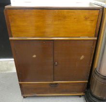 A 1950s fruitwood cocktail cabinet with a rise and fall top, over two doors, raised on casters  38"h