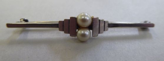 An Art Deco 9ct white gold bar brooch, set with two pearls