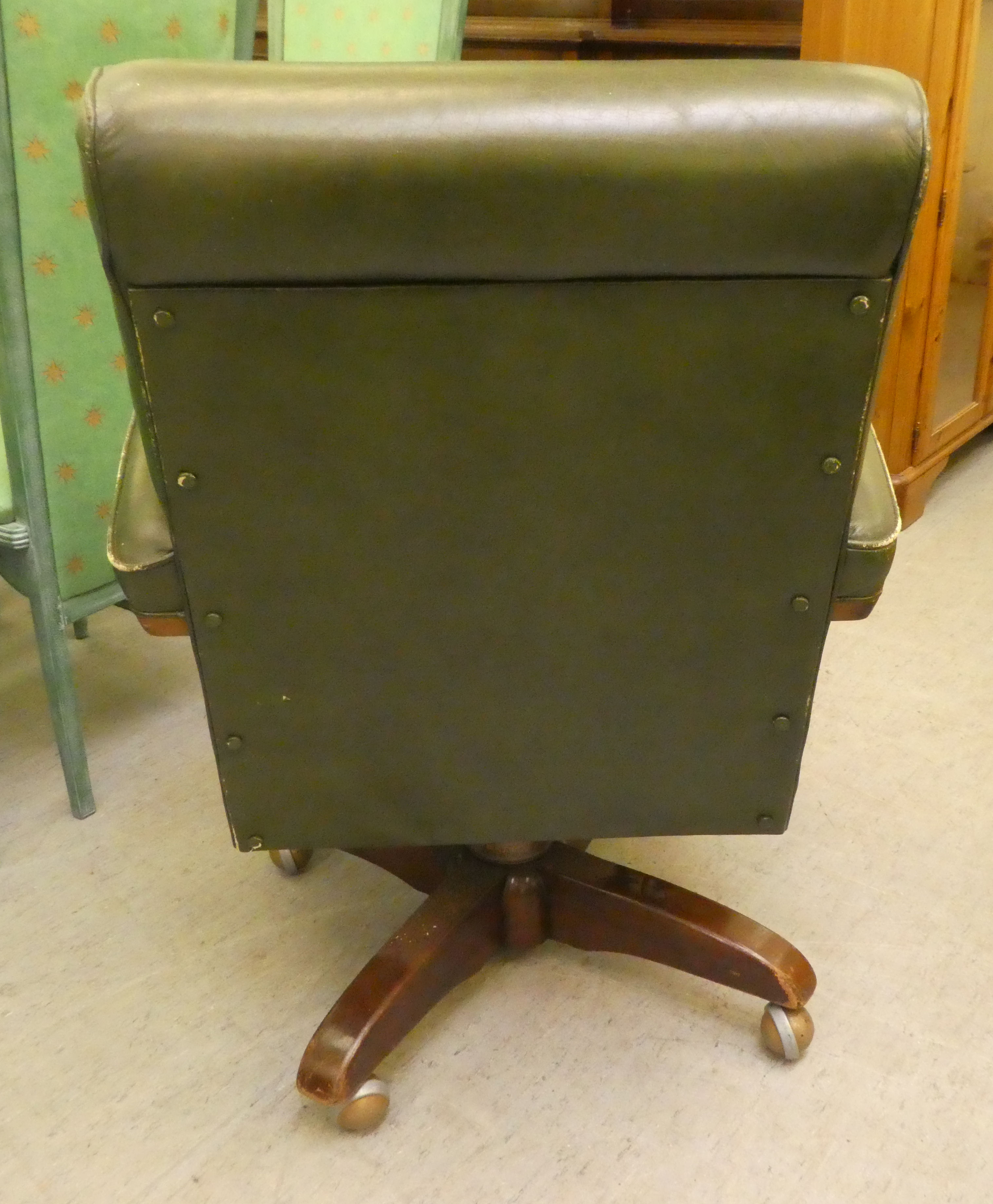 A mid 20thC faux green hide upholstered swivel office chair, raised on a splayed pedestal base - Image 5 of 5