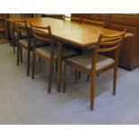A 1970s teak G-Plan dining table, raised on turned, tapered legs  29"h  62"L extending to 80"L