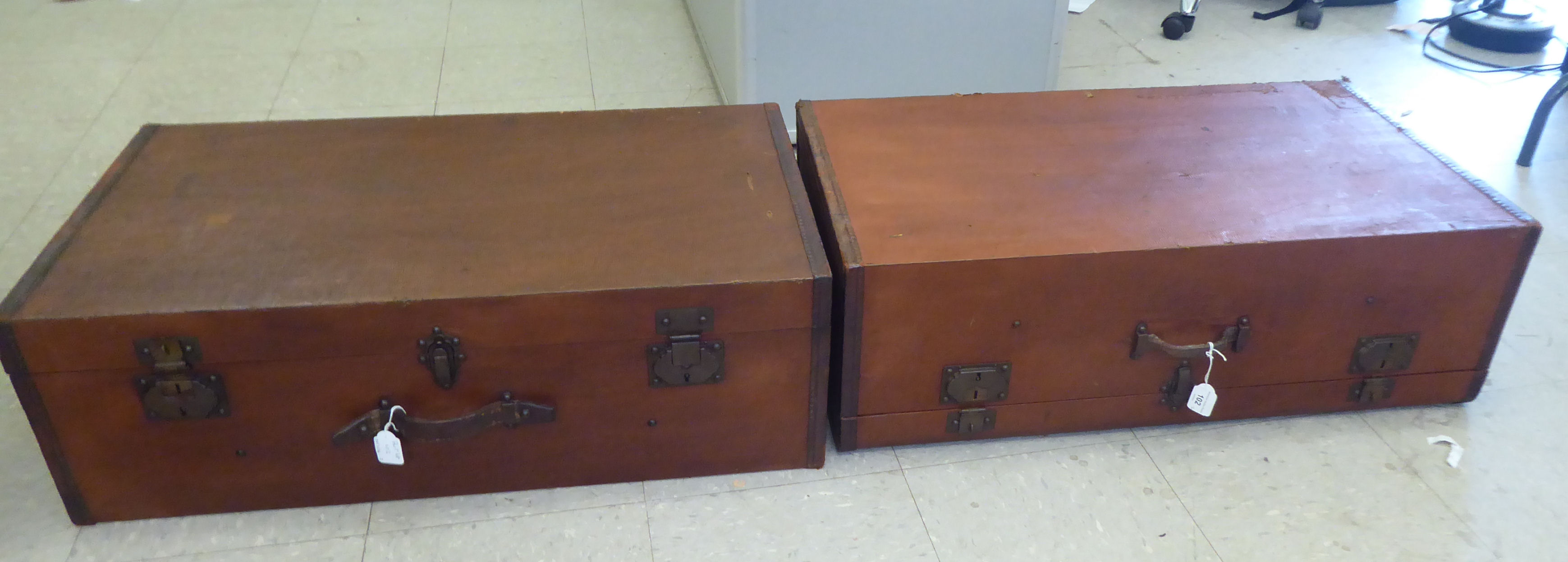 Two vintage hide bound and brown faux hide finished automobile trunks and iron fittings  each 10"