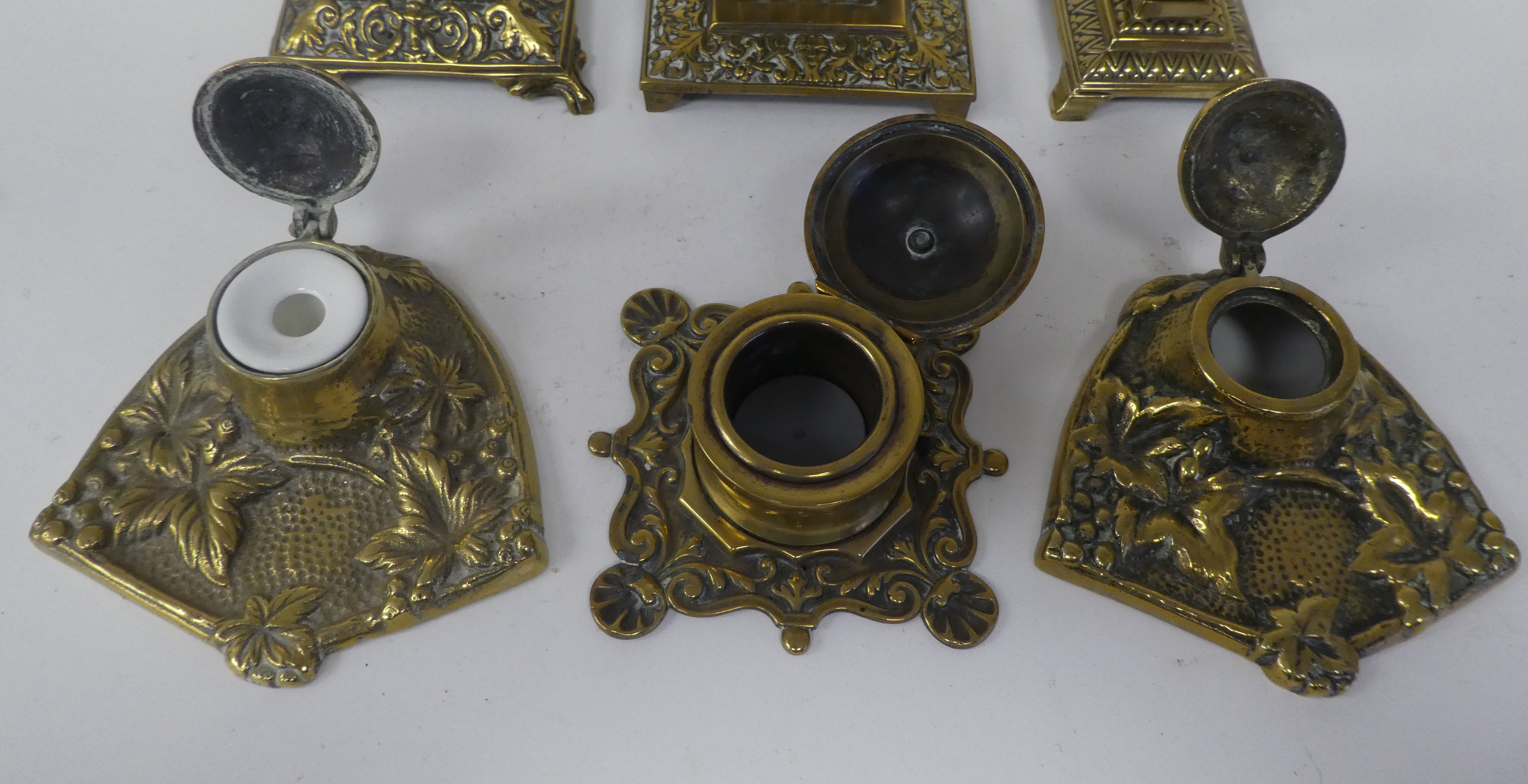 Six variously designed, early/mid 20thC decoratively cast brass desktop lidded inkwells - Image 2 of 4