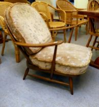 An Ercol mid brown elm spindle back armchair, raised on turned legs