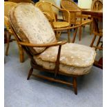 An Ercol mid brown elm spindle back armchair, raised on turned legs