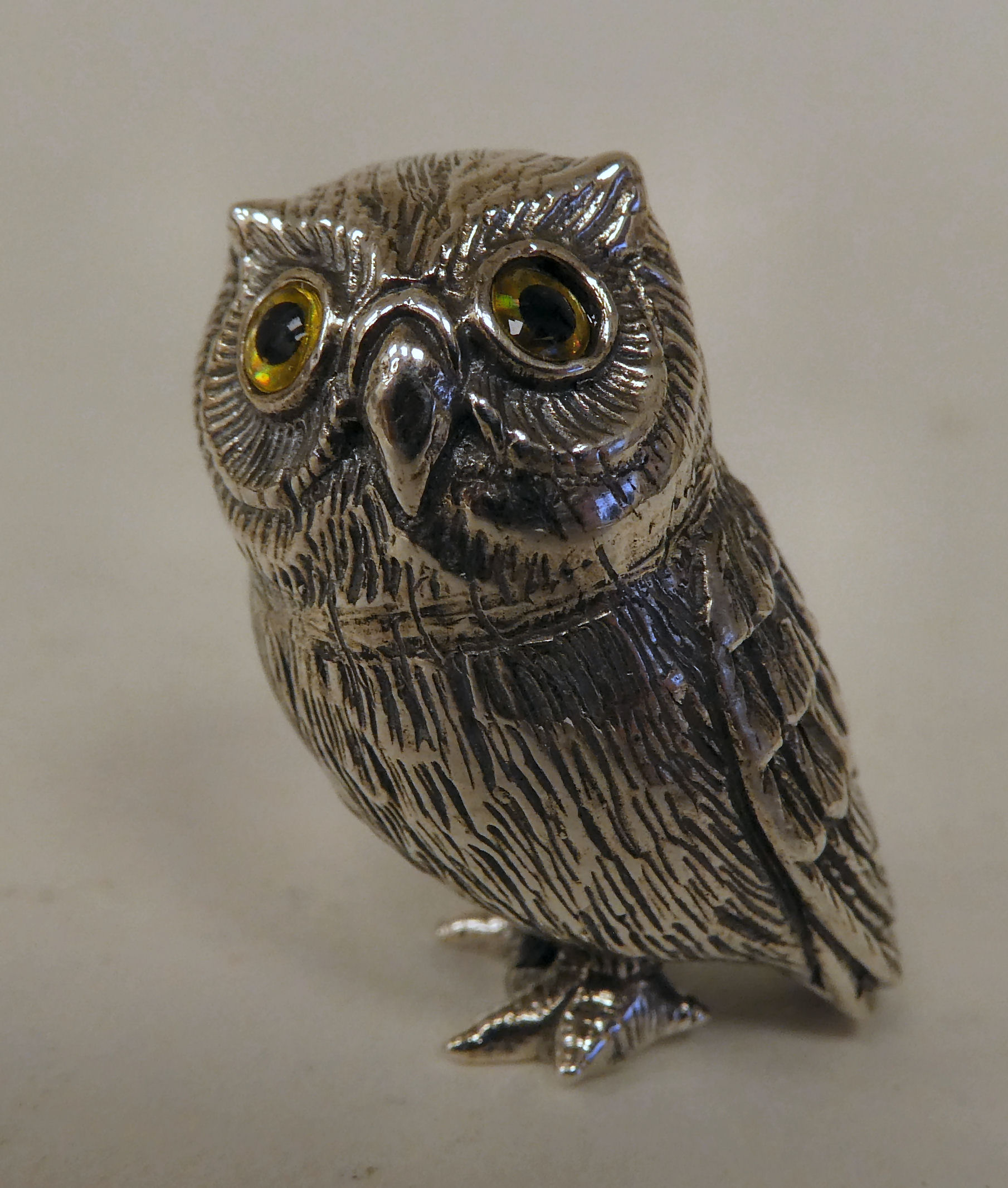 A silver coloured metal miniature model owl  stamped Sterling