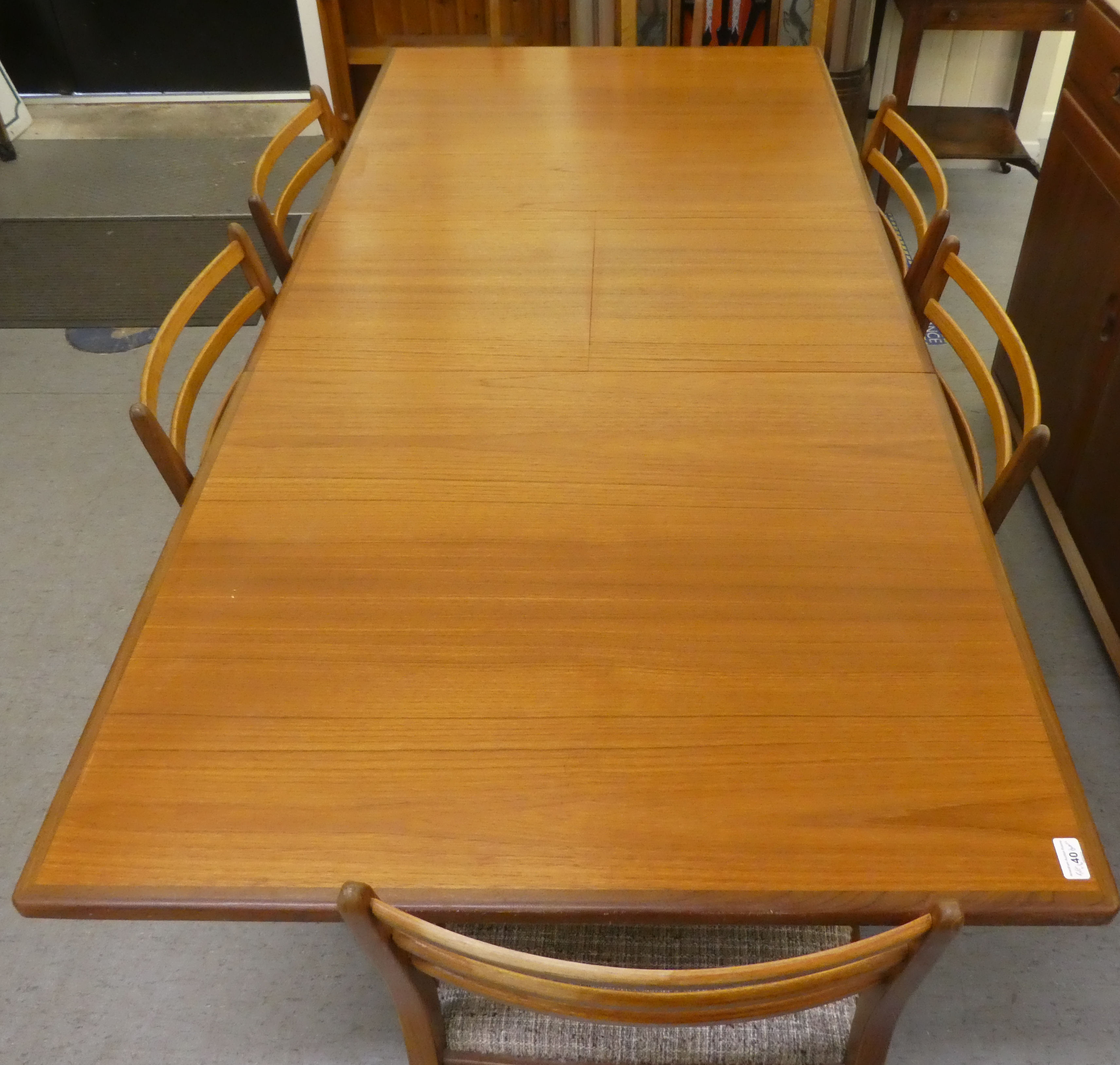 A 1970s teak G-Plan dining table, raised on turned, tapered legs  29"h  62"L extending to 80"L - Image 7 of 8
