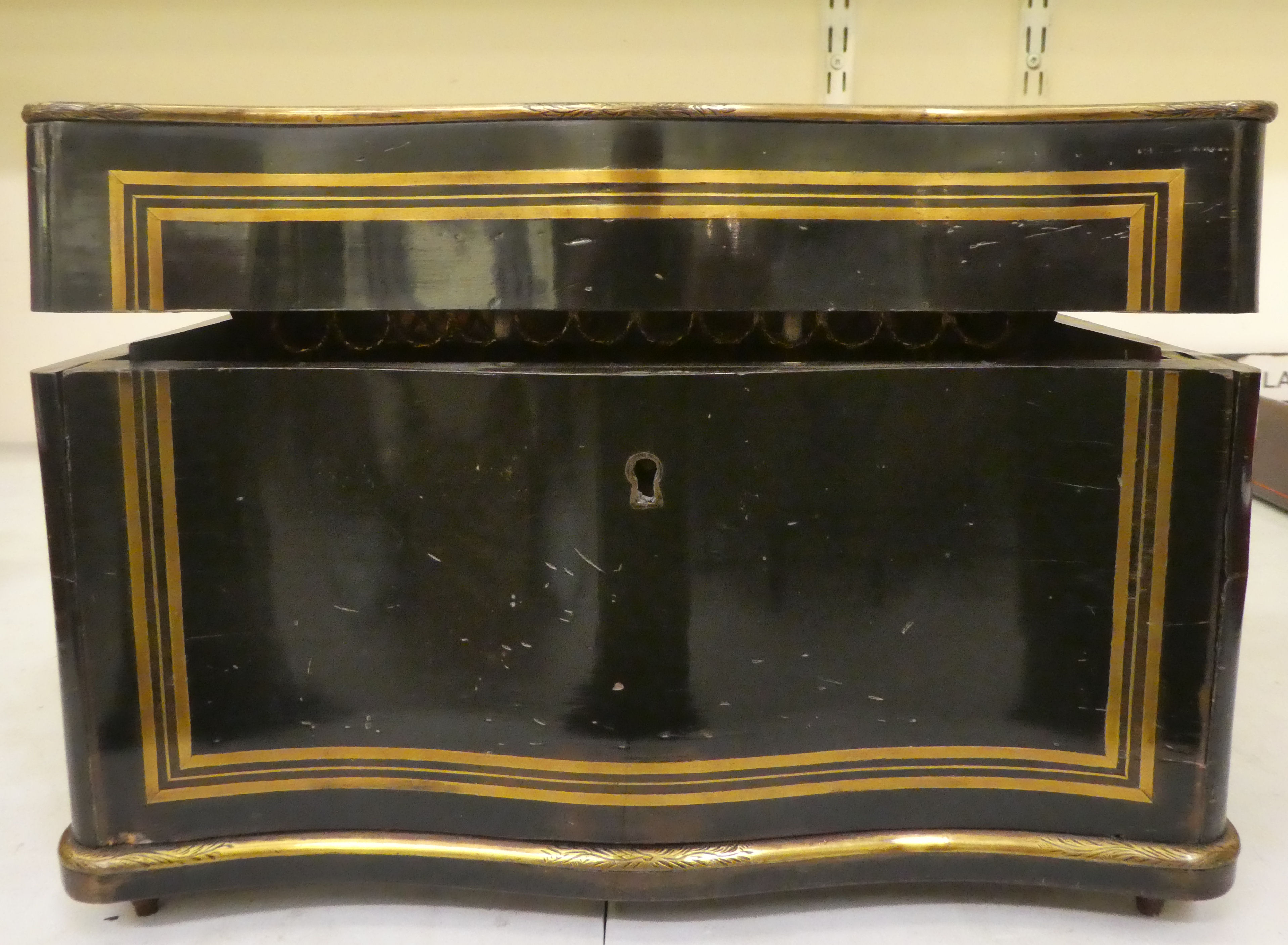 A 19thC black lacquered and gilded metal, serpentine front desktop humidor, finely decorated with