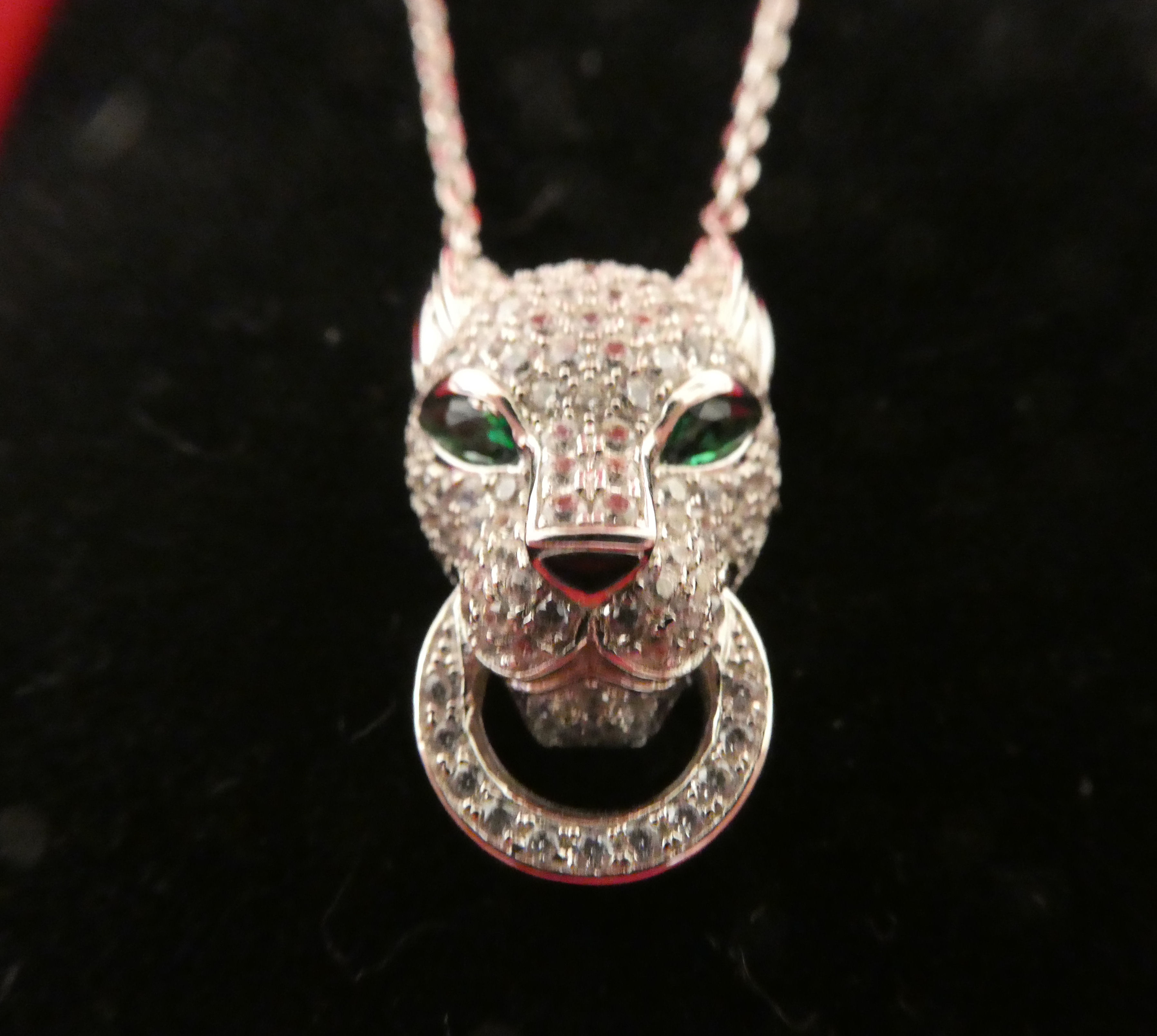 A silver coloured metal, cubic zirconia set panther's head pendant with emerald eyes  stamped 925, - Image 2 of 2