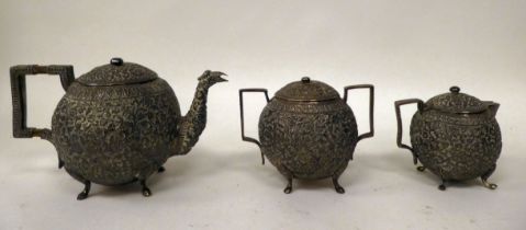 An early 20thC Indian white/silver coloured metal three piece tea set of globular form, allover