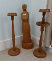 A wooden sculpture, initialled MTB  28"h; and two light oak pedestal ashtrays  23"h