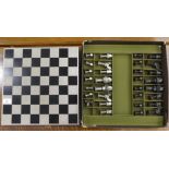 A novelty chess set, the metal board  14"sq the pieces fashioned out of nuts and bolts