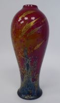 A Royal Doulton flambé glazed, drip painted and gilded china vase of slender, waisted, baluster form