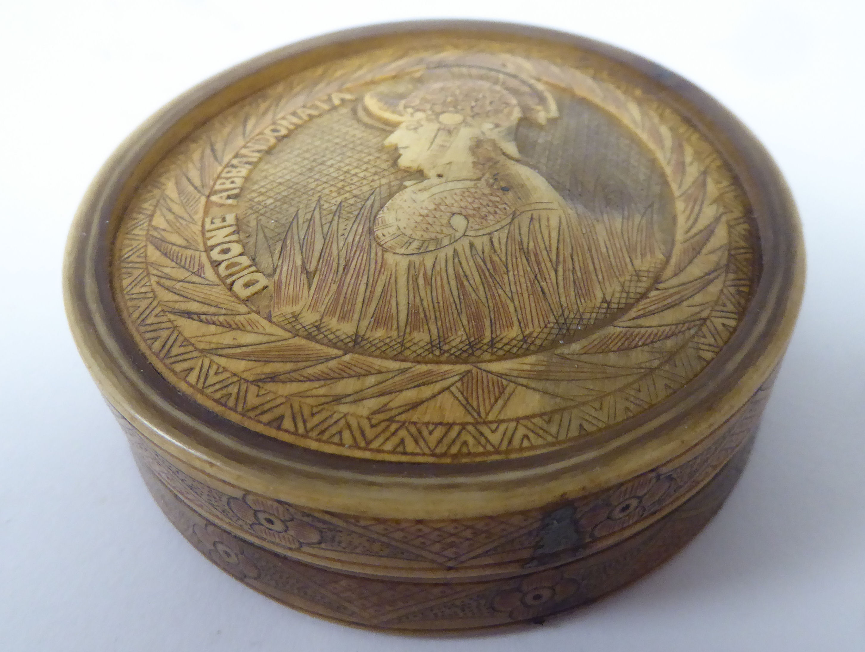 An 18th/19thC Italian bone disc shaped snuff box and cover, decorated in relief with carved