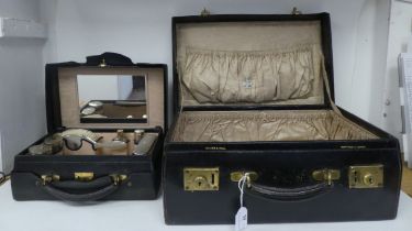 A Walker & Hall stitched dark blue hide vanity case with gold plated locks, the hinged lid enclosing