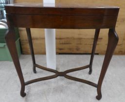 A mid 20thC mahogany bow front canteen, raised on tapered legs  29"h  26"w containing a miscellany