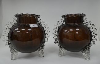 A pair of semi-opaque aubergine coloured and clear glass, globular vases, in the manner of